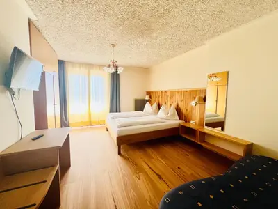 a hotel room with a bed and a mirror at LAKE & RIVER Hotel in Carezza al Lago