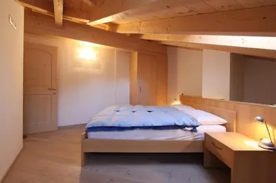 a bedroom with two bunk beds in a room at Varesco Appartamenti in Carano
