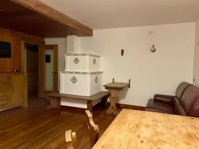 a living room with a table and a couch at home in dolomiti in Villanova