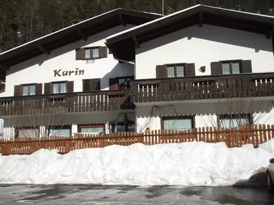a building with snow in front of it at Appartamenti Callori Karin in Canazei