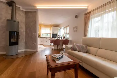a living room with a couch and a table at Ba mir Apartment in Appiano sulla Strada del Vino