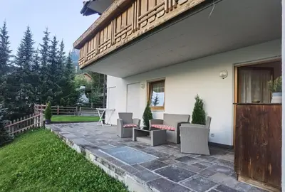 a patio with chairs and tables on a house at Apartment Enrosadira Pedraces in Badia