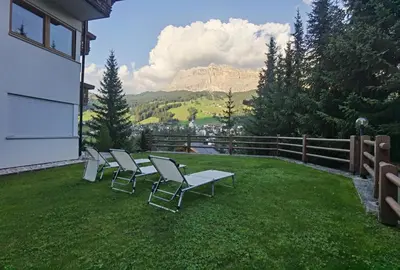 a group of chairs and a table on a lawn at Apartment Enrosadira Pedraces in Badia
