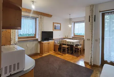 a kitchen and dining room with a table at Apartment Enrosadira Pedraces in Badia