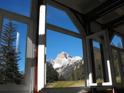 a window with a view of a mountain at Villaggio Turistico Ploner in Carbonin