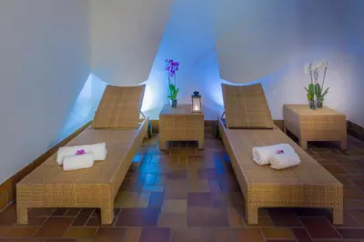 two wicker chairs with towels on them in a room at Villaggio Turistico Ploner in Carbonin