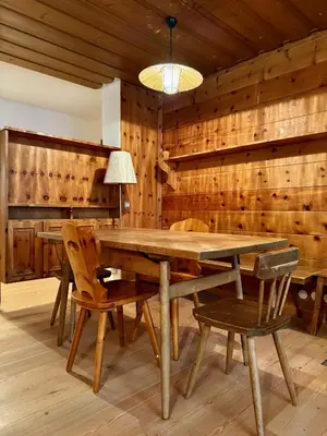 a wooden dining room with a wooden table and chairs at Spacious Alpine Retreat & Parking in Cortina dʼAmpezzo