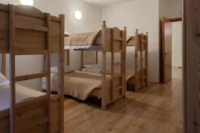 a group of bunk beds in a room at Ostello IMPERINA in Zenich