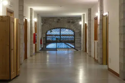 an empty hallway with a large window in a building at Ostello IMPERINA in Zenich