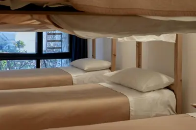 a bedroom with two bunk beds and a window at Ostello IMPERINA in Zenich
