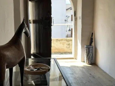 a statue of a dog standing on a glass table at Alte Stube - Antica dimora nelle Dolomiti in Transacqua