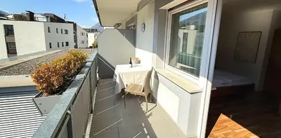 a table with a blue table cloth and a bowl on it at Residence Ferienwohnungen Santner - Moderne zentrale Ferienwohnungen in Naturns Südtirol - mit Parkplatz in Naturno