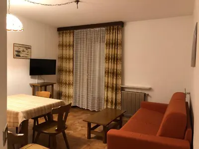 a living room with a couch and a table at CASA PINUCCIA APPARTAMENTO OVEST in Predazzo