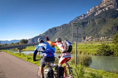 two people on bikes on a road next to a river at Haus Zöschg in Andrian
