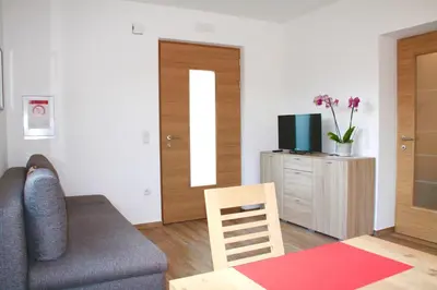 a living room with a couch and a television at Haus Zöschg in Andrian