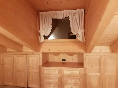 a room with wooden cabinets and a mirror at Casa De Sandre in San Vito di Cadore
