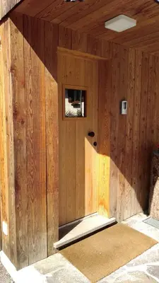 a wooden building with a small window in it at Casa De Sandre in San Vito di Cadore