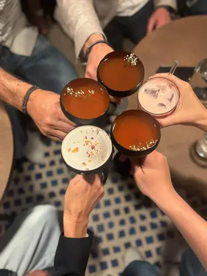 a group of people holding up their drinks at Boutique Hotel Badhaus in Bressanone