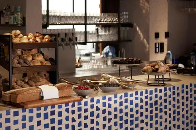 a counter with various types of bread and pastries at Boutique Hotel Badhaus in Bressanone