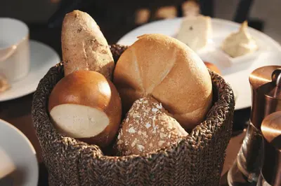 a basket filled with bread on top of a table at Boutique Hotel Badhaus in Bressanone