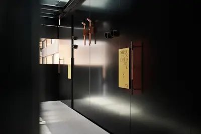 a room with a door with a sign on it at Boutique Hotel Badhaus in Bressanone