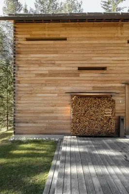 a wooden building with a wood wall at Mountain Lodge Tamersc in San Vigilio Di Marebbe