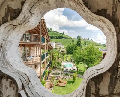 a view from a hole in the wall of a building with a view at Langenmantel Historic Suites in Termeno