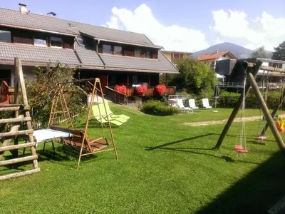 a yard with a swing set and a playground at Ferienwohnungen Schnarf in Valdaora