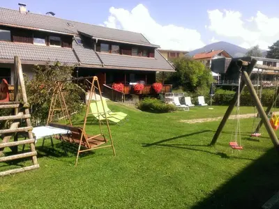 a yard with a swing set and a playground at Ferienwohnungen Schnarf in Valdaora