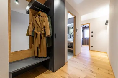 a hallway with a coat rack in a house at Rienz Alpine City Suites in Brunico