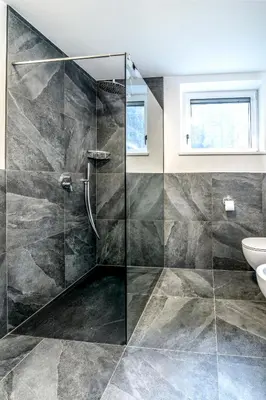a bathroom with a glass shower and a sink at Apartmenthouse STERN in Vipiteno
