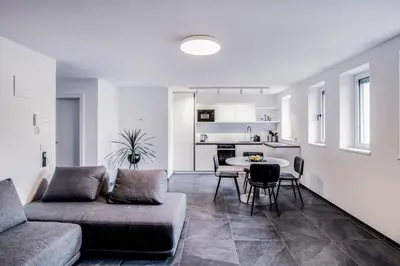 a living room with a couch and a table at Apartmenthouse STERN in Vipiteno