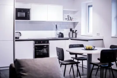 a kitchen with a table and chairs and a counter top at Apartmenthouse STERN in Vipiteno