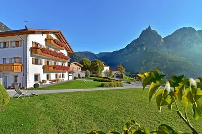 a view of a building with mountains in the background at Formsunhof in Siusi