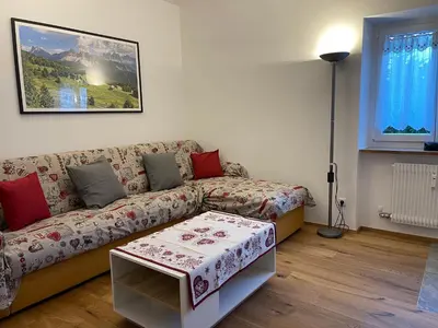 a living room with a couch and a table at Apartment Weisswand in Colle Isarco