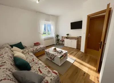 a living room with a couch and a table at Apartment Weisswand in Colle Isarco