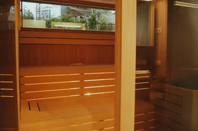 a walk in closet with a glass door at Solterra Poolhouse 2 in Tisens