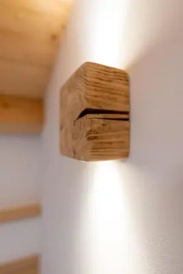 a wooden object on the side of a wall at Chalet Le Grazie in Le Grazie