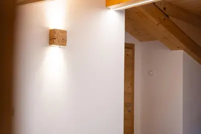 a light on the wall of a room at Chalet Le Grazie in Le Grazie