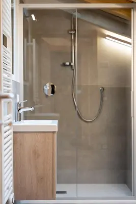 a bathroom with a shower with a sink at Chalet Le Grazie in Le Grazie