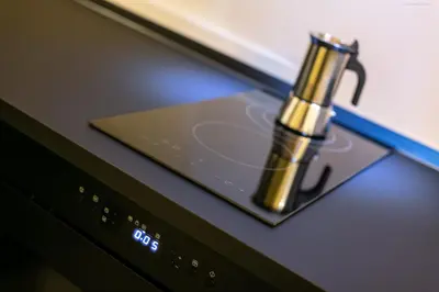 a golden perfume bottle sitting on top of a microwave at Apartment Bolzano in Bolzano