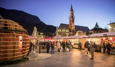 a group of people walking around a christmas market at Apartment Bolzano in Bolzano
