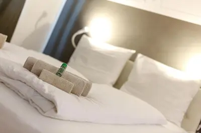 a pile of towels sitting on top of a bed at Apartment Bolzano in Bolzano