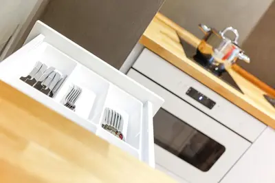 a kitchen with a sink and a white cabinet at Apartment Bolzano in Bolzano