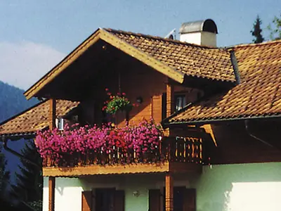 a house with a balcony with pink flowers on it at Apartment Obkircher in Nova Levante