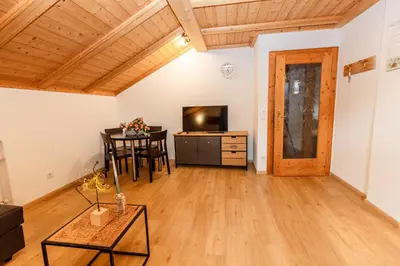 a living room with a table and a television at Apartment Obkircher in Nova Levante