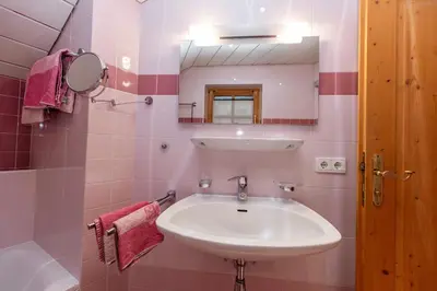 a bathroom with a sink and a mirror at Apartment Obkircher in Nova Levante