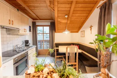 a kitchen with a sink and a table in a room at Apartment Obkircher in Nova Levante