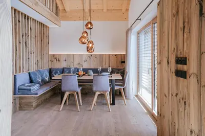 a dining room with a table and chairs at Chalets Hansleitner in Terento