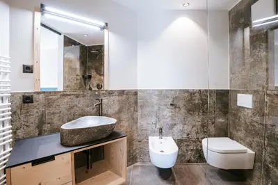 a bathroom with a sink and a toilet at Chalets Hansleitner in Terento